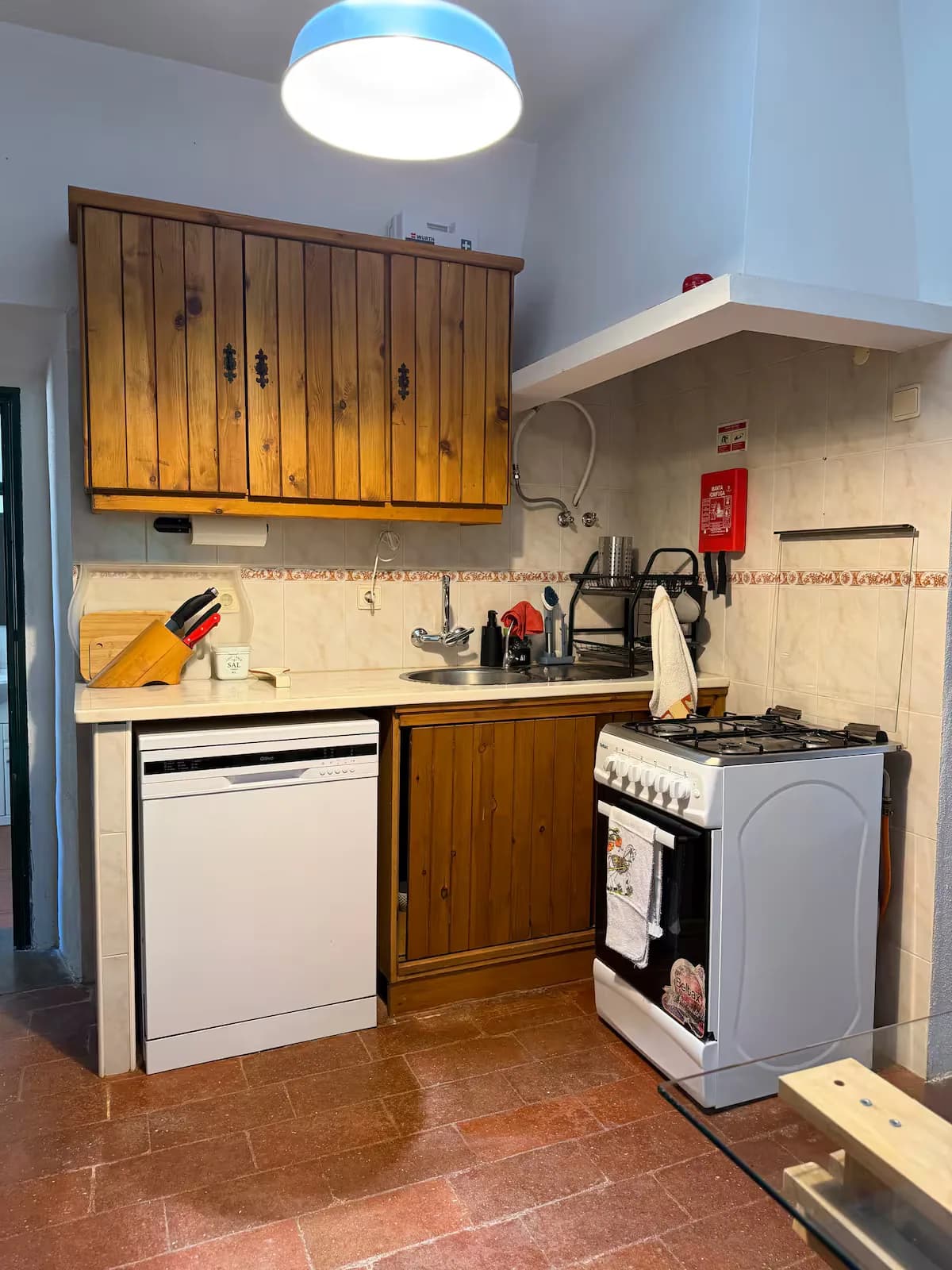 Kitchen with wooden cabinets and a cooker