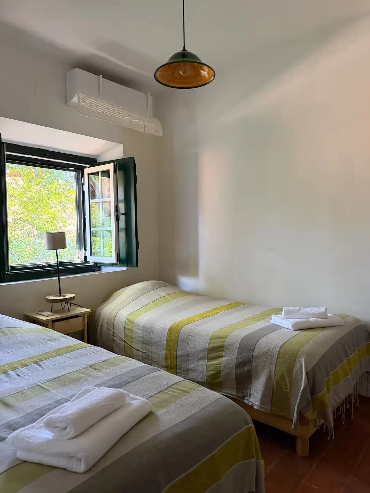 Twin bedroom with towels laid out